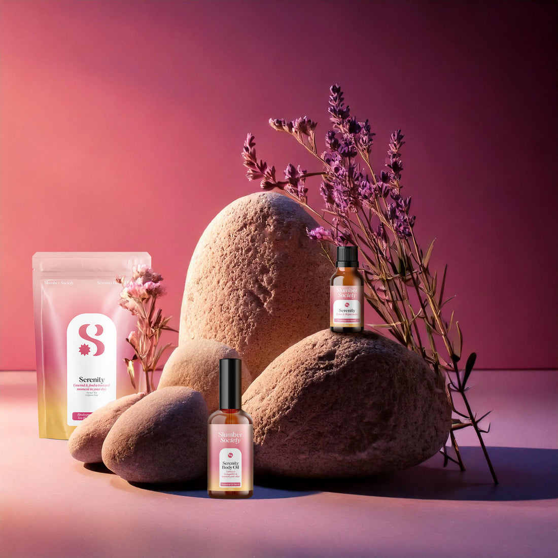 Slumber Society Serenity Herbal Tea, Body oil and Essential Oil on boulders with lavender plants.