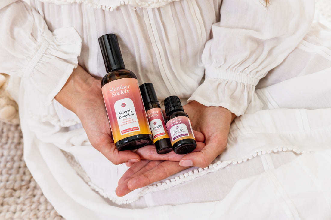 Model holding Serenity Body Oil, Roll On and Essential Oil in her hands