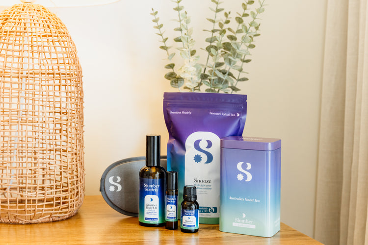 Slumber Society Slumber bundle featuring herbal tea, tea tin, contoured eye mask, body oil, roll on and essential oil.