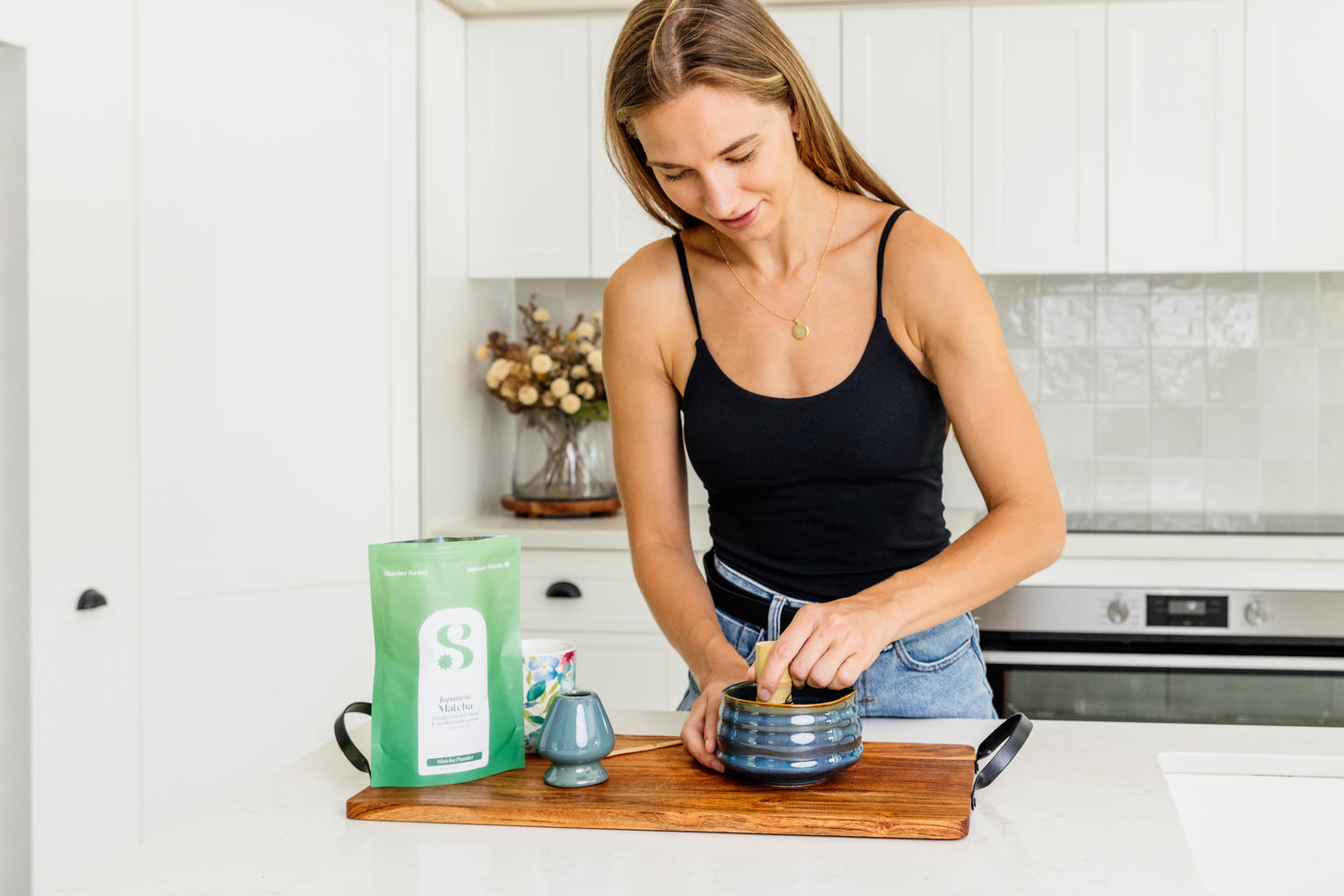 model making a Slumber Society Japanese matcha in a matcha set