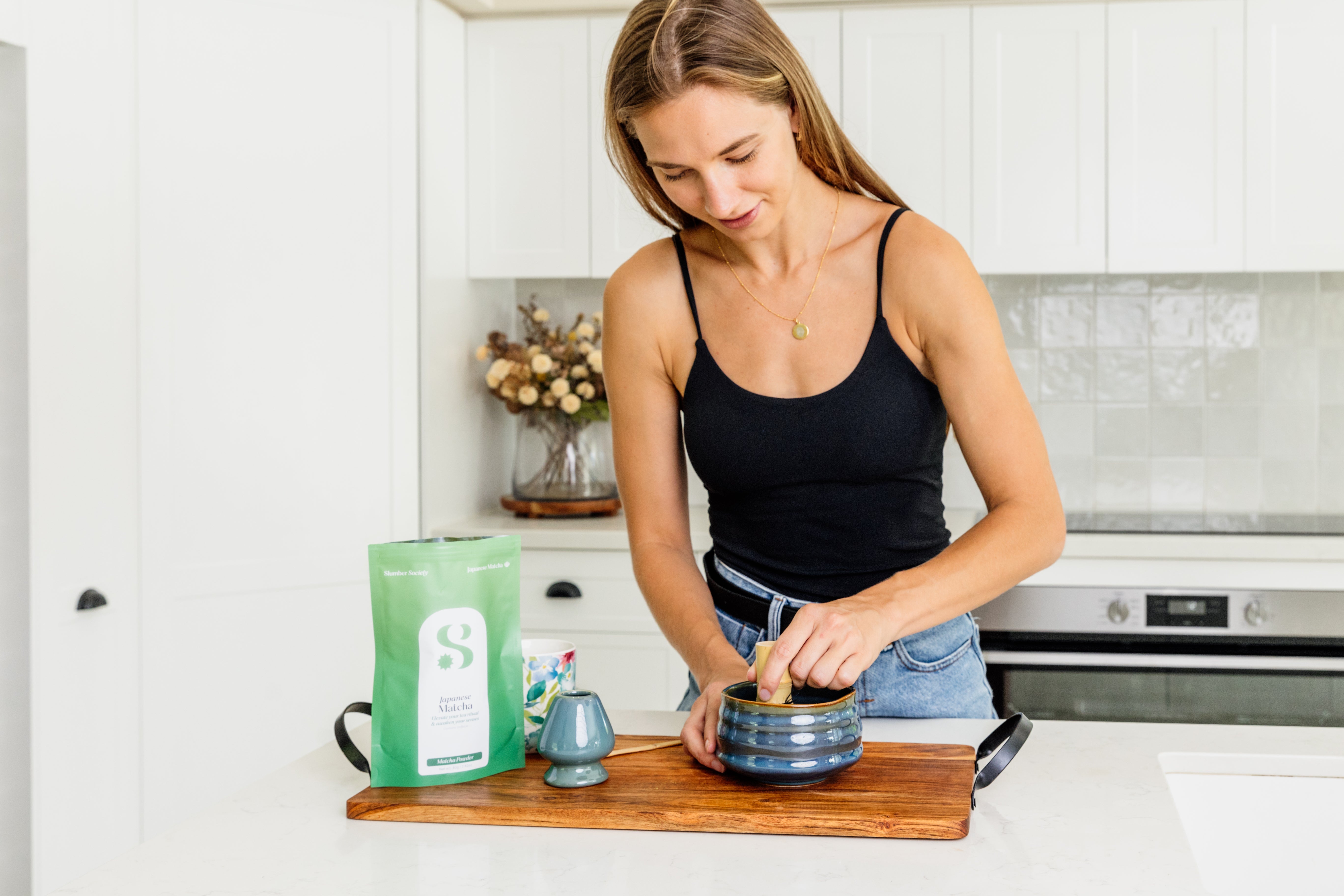 model making a Slumber Society Japanese matcha in a matcha set